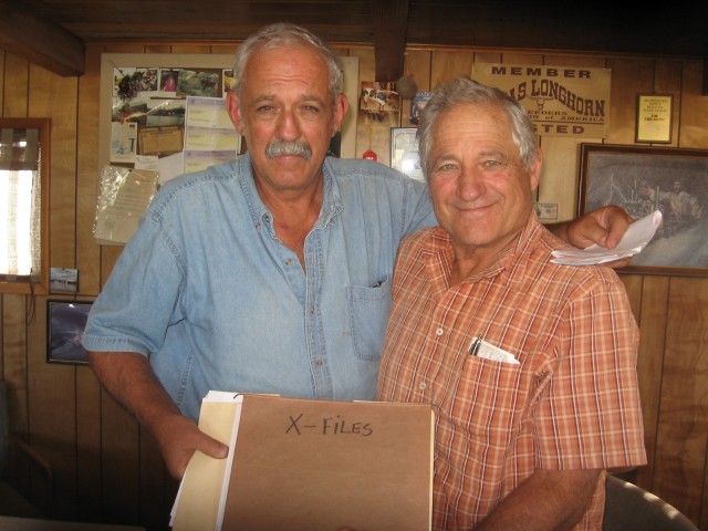 The Fazio brothers, Ricard, l, and Al, r, displaying their "X-Files" folder, containing pictures of the cattle mutilations that occured in 1991.